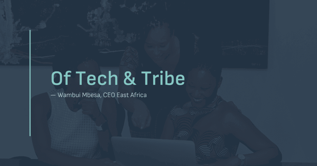 Three women smiling and collaborating around a laptop, with the blog title "Of Tech & Tribe" and the author credit "Wambui Mbesa, CEO East Africa" overlaid on the image.